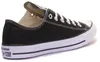 A black Converse All Star shoe is shown from the side against a white background. Voir les images du produit