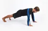 A man is performing a plank exercise with a resistance band around his shoulders and hands. Podgląd zdjęcia produktu