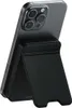 A black Satechi magnetic power bank with a stand function attached to the back of a gray smartphone. Produktbild-Vorschau