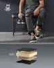 A man is sitting on a shoe bench with a shoe rack underneath. A diagram below shows the layered structure of the shoe bench cushion. Produktbild-Vorschau