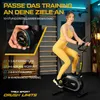 A woman is using a stationary bike in a home gym setting, with text overlays highlighting product features. Produktbild-Vorschau
