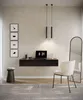 A modern home office or dressing area with a floating desk, chair, mirror, and artwork. Produktbild-Vorschau