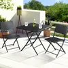 A black polyrattan bistro set with two chairs and a table on a patio. Produktbild-Vorschau