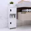 A white bathroom cabinet with two doors and an open shelf, placed on a marble floor next to a marble tiled wall. Produktbild-Vorschau