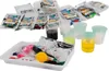 A collection of items for a science experiment kit, including small bags of ingredients, beakers with colored liquids, and a white tray with various tools and supplies. Náhled obrázku produktu