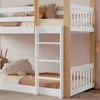 A close-up view of a white and wood bunk bed with bedding and stuffed animals. Produktbild-Vorschau