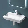 A white ceramic sink with a modern faucet is mounted on a blue wall, with a backlit mirror above. Produktbild-Vorschau