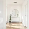 A hallway with a console table, a round mirror, and a potted plant. Anteprima dell’immagine prodotto