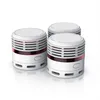 Three white smoke detectors are arranged in a group on a white background. Produktbild-Vorschau