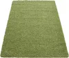 A green shaggy rug is shown from a slightly elevated angle against a white background. Podgląd zdjęcia produktu