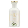 A white perfume bottle with gold and green accents. Voir les images du produit