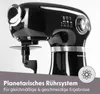 A close-up shot of a black kitchen mixer with silver accents, placed on a gray surface with some text and a graphic overlay. Produktbild-Vorschau