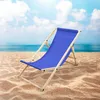 A blue beach chair on a sandy beach with the ocean and sky in the background. Náhled obrázku produktu