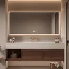 A modern bathroom vanity with a large LED mirror, sink, and storage cabinets. Anteprima dell’immagine prodotto