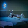 A baby changing station at night, illuminated by a blue night light. Voir les images du produit