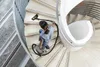A person vacuuming a spiral staircase. Náhled obrázku produktu