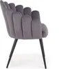 A side view of a dark gray velvet chair with a scalloped back and black legs, isolated on a white background. Produktbild-Vorschau