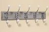 A wall-mounted coat rack with five hooks. Náhľad obrázku produktu