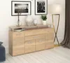A wooden sideboard with four doors and drawers, decorated with vases and artwork on top, in a room with a floor lamp and curtains. Produktbild-Vorschau