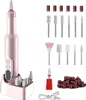 A pink electric nail drill with various bits and accessories on a white background. Produktbild-Vorschau
