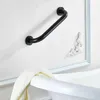 A black grab bar is mounted on a white wall above a white bathtub with a towel draped over the edge. Produktbild-Vorschau