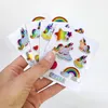 A hand holding a set of unicorn stickers. Produktbild-Vorschau
