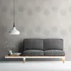 A modern living room setting with a sofa and a side table against a patterned wall. Produktbild-Vorschau