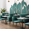 A modern restaurant or cafe interior with teal seating and decorative wall panels. Anteprima dell’immagine prodotto