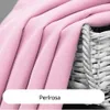 A close-up of pink fabric draped over a wicker basket. Produktbild-Vorschau