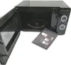 A black Cecotec microwave with its door open, and an instruction manual lying in front of it. Anteprima dell’immagine prodotto