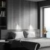 A bedroom scene with a bed, headboard, and wall lamps. Náhled obrázku produktu