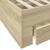 Close-up view of the corner of a wooden bed frame with a drawer pulled out. Podgląd zdjęcia produktu