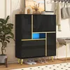 A black shoe cabinet with gold accents and a blue interior compartment, shown in a home entryway with shoes on the floor. Podgląd zdjęcia produktu