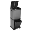 A gray and black multi-compartment trash can with two lids on top and a pull-out drawer at the bottom, shown against a white background. Produktbild-Vorschau