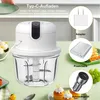 A mini electric chopper is shown on a table with various charging accessories and food items. Produktbild-Vorschau