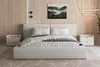 A bedroom scene with a bed, nightstands, and wall art. Produktbild-Vorschau