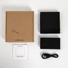The image shows the contents of a coffee scale product box, laid out on a white surface. This includes the box itself, the scale, a charging cable, and an instruction manual. Produktbild-Vorschau