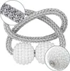 A close-up view of two magnetic curtain tie-backs. Produktbild-Vorschau