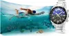 A swimmer in the ocean next to a watch. Voir les images du produit