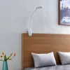 A clip-on LED lamp attached to the headboard of a bed. Produktbild-Vorschau