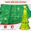 A close-up view of a lit-up artificial Christmas tree with decorative elements and text overlays. Náhled obrázku produktu
