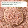 A wooden spoon filled with psyllium seeds, with more seeds scattered in the background. Produktbild-Vorschau