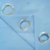 Close-up of a blue fabric curtain with grommets. Voir les images du produit