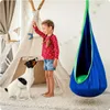A young girl and her dog are playing in a room with a teepee and a hanging chair. Produktbild-Vorschau