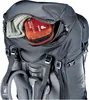 Close-up view of the top compartment of a backpack, showing a first aid kit and a rolled-up garment. Produktbild-Vorschau
