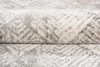 A close-up, folded view of a textured rug with a geometric pattern. Anteprima dell’immagine prodotto