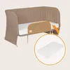 A baby crib with a side rail and a mattress shown in a circle. Náhľad obrázku produktu