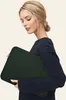 A woman is holding a laptop sleeve. Náhľad obrázku produktu