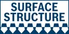 The image shows the words "SURFACE STRUCTURE" in large, bold, dark blue letters against a white background. Below the text is a decorative pattern of interlocking white shapes with dark blue outlines, resembling a checkered or tiled surface. Anteprima dell’immagine prodotto