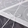 A close-up view of a white ribbon tied in a bow around a dark-colored item, possibly a book or a gift, with a translucent white overlay featuring circular patterns and text. Produktbild-Vorschau